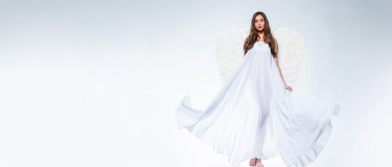 Banner with sexy angelic woman. Valentines day and costumes concept. Young woman in angel costume. Angel with gift. Fallen white angel. Beautiful woman posing with angel wings.