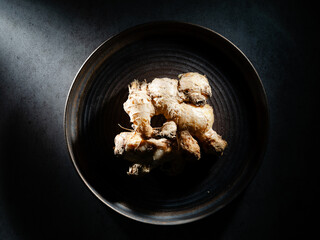 Fresh ginger on dark background