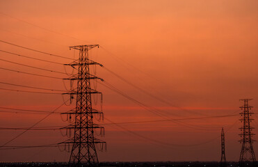 High voltage electric pole isolated on sunset sky background. electrical energy concept	
