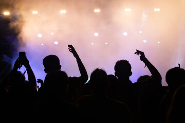 Fototapeta premium Abstract photo of crowd at concert and blurred stage lights.