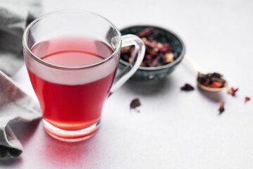 Obraz na płótnie Canvas Glass cup of hot hibiscus tea.