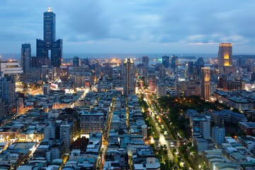 Aerial view of Kaohsiung City at dusk, a vibrant seaport in South Taiwan, with the famous landmark...