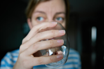 Woman drinks water, Close-up shot of woman drinking fresh clean water from glass, Quenching thirst,...