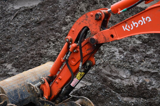 Kubota excavator digging in the mud.