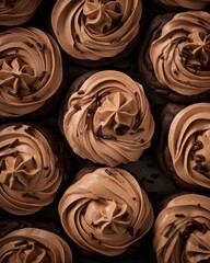  a close up of chocolate cupcakes with chocolate frosting on top of each of the cupcakes.
