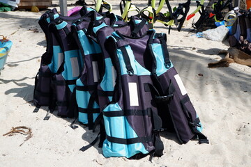 blue life jacket or safety buoy on the beach sand. Illustrative example of the wrong color of buoy...