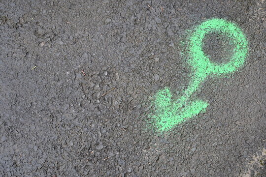Sewer line marking painted on asphalt.