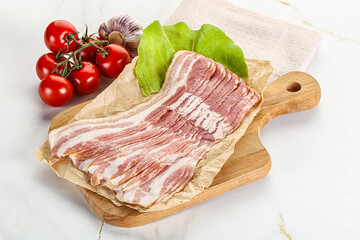Sliced pork bacon oved board