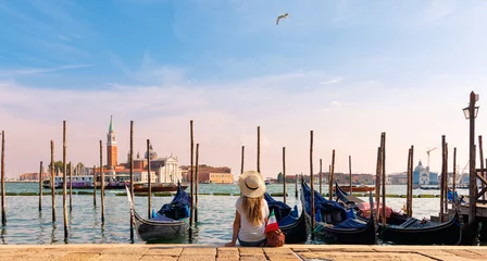 Foto op Aluminium Woman tourist sitting and looking typical gondola on the canal- Venice, Italy © M.studio
