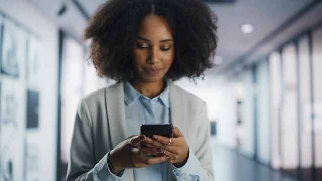 Cheerful Black Girl Using Mobile Phone to Message People on Social Media. Close Up Focus Switching from Hands to Face. Stylish Young Female Connecting with Friends and Business Partners Online