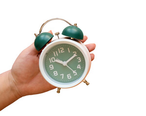 Hand holds classic green alarm clock on transparent background