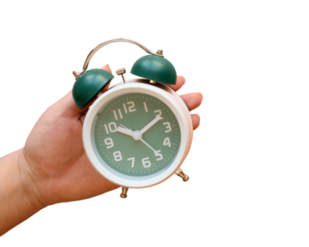 Hand holds classic green alarm clock on transparent background