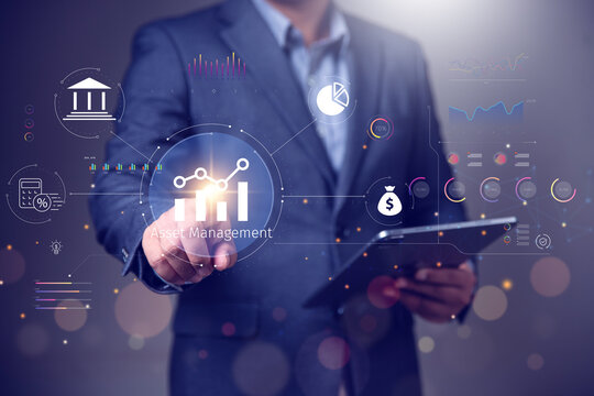 Asset management concept, Businessman using tablet and touch asset management Icon  on virtual display. Financial Property Digital assets.