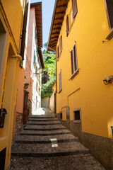 italian picturesque street yellow facade house building in beautiful Bellagio Como lake in north Italy