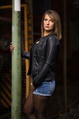 Thirty woman brunette portraits low key photographed with studio flash.