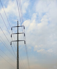 power line tower with blue cloudy sky