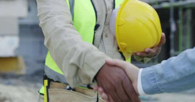 Construction worker, man with handshake and welcome for industry onboarding, engineering and building agreement. Project manager, builder or african contractor shaking hands for deal and partnership
