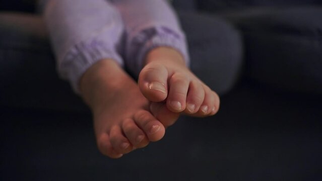 Barefoot Child Relaxing on Couch