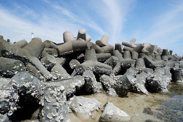 concrete tetrapod breakwater stones are stacked to prevent abrasion