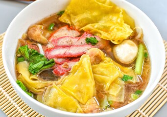Wonton soup with bbq pork or  roasted pork , thai food, asian , chinese food, on white bowl