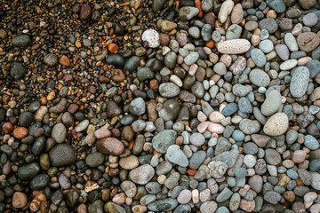 Wet pebble stones on the beach