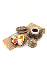 Turkish Coffee with Turkish Delight on authentic metal plate, isolated on white background