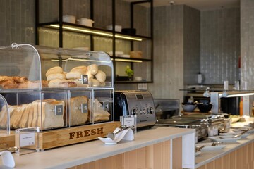 Assortment of sliced bread, rolls, croissants and pastries at the breakfast counter of the Plaza...