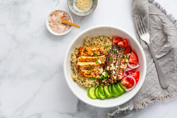 Healthy bowl with cauliflower rice, enoki mushrooms, chicken and vegetables.
