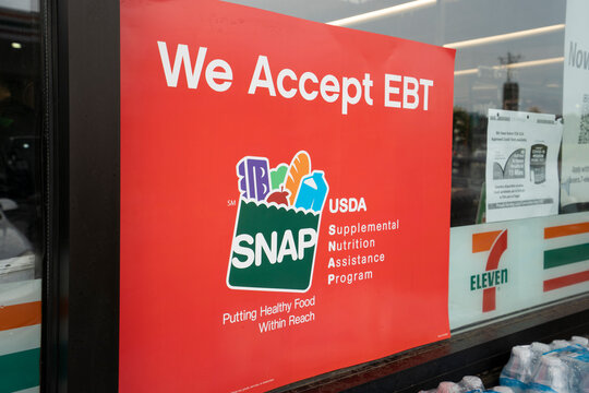 Spartanburg, SC, USA - June 17, 2022: We Accept EBT sign is seen outside a 7-Eleven store in Sartanburg, South Carolina. The Supplemental Nutrition Assistance Program (SNAP) is a federal program.