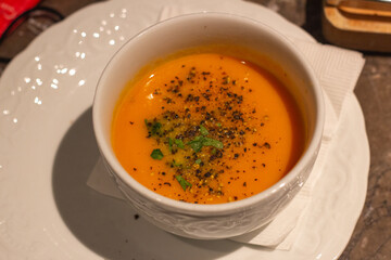 Top down view of a bowl of pumpkin cream soup on table. Kowloon Tong, Hong Kong