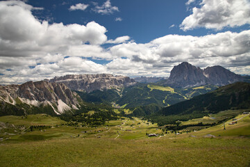 Fototapeta na wymiar Mountain huts with the beautiful mountainous landscape of Val Gardena in Dolomites.