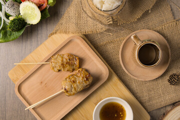 Fototapeta na wymiar Grilled pork with Sticky rice that is easily found in Thailand.