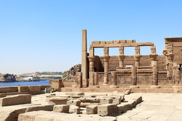 Temple of Isis on Agilkia Island (Philae) and Nile river, reservoir of Aswan Low Dam, Egypt. Summer vacation, relaxing on cruise ships - obrazy, fototapety, plakaty