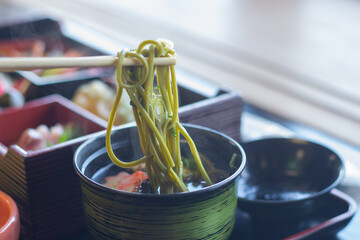 Close up of a bowl of delicious matcha green tea soba noodles (Japanese noodles), Uji, Kyoto, Japan