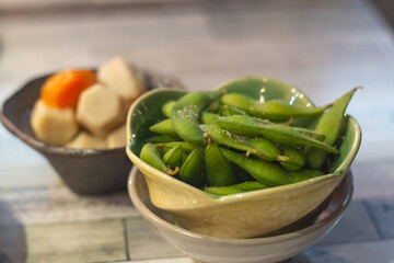 Close up of a bowl of fresh green soybeans or edamame on table, Osaka, Japan