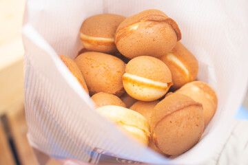 Close up of a paper bag of delicious baby castella cake in Katsuoji Temple