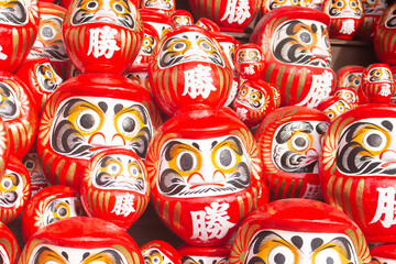 Many red daruma dolls or dharma dolls in Katsuo-ji temple. The Kanji translated to English : 'Victory'.