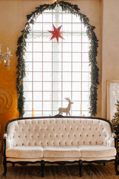 Bright interior with a large Christmas decorated window