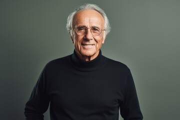 Portrait of a smiling senior man in glasses and a black sweater.