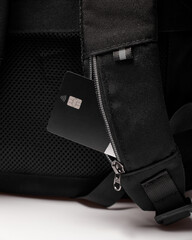 a card pocket on the shoulder strap of the backpack along with a bank card