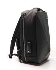 black backpack with asymmetrical design and matte finish, side view. youth backpack with a...