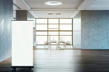 Contemporary spacious coworking office room interior with empty white mock up roll up banner and...