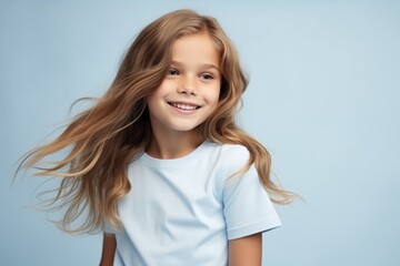beautiful little girl with long hair on a blue background in studio