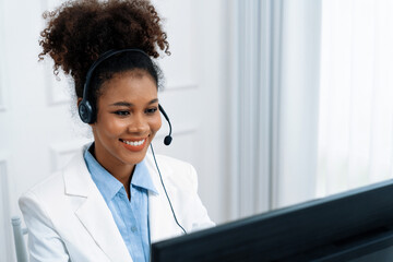 African American businesswoman wearing headset working in office to support remote crucial customer...