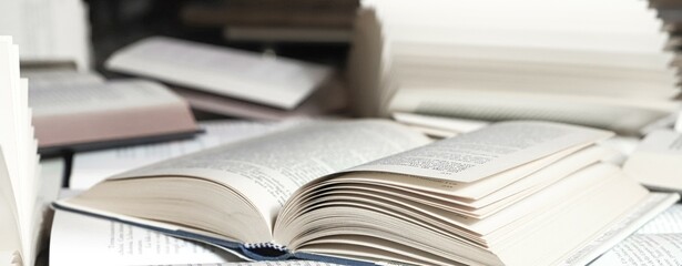 stack of books, close up. Open book on the table in library. Back to school concept. Open book on...