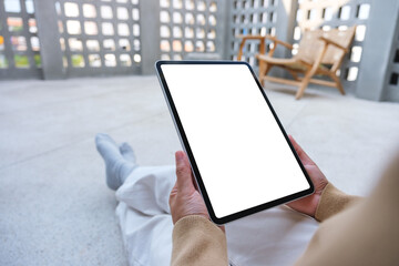 Mockup image of a woman holding digital tablet with blank white desktop screen
