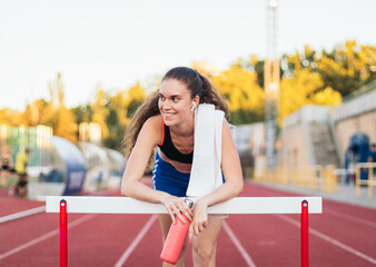 An athletic woman resting after running.