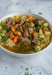 Beef noodle soup with vegetables on a plate isolated on light background.
