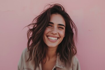 Fototapeta premium Confident Brunette Woman with Wavy Hair on Pink Background