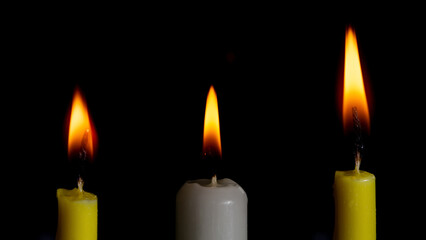 candles collection on the black background close up